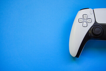 Video games white gaming controller joystick isolated on blue color sky background, top view with...