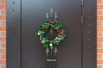 Christmas wreath on a metal door closeup