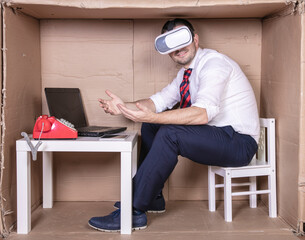 businessman in virtual reality glasses spreads out his hands helpless