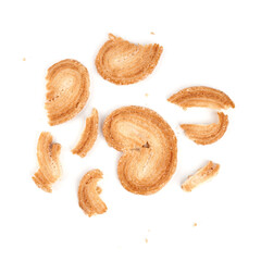 Puff pastry cookies. Fresh puff pastry cookies in the shape of a heart. Classic French pastries. Pig ear, elephant ear cookies, French hearts. Heart shaped puff pastry isolated on white background