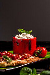 Toasts with sundried tomatoes and cream cheese on dark background. vertical image, place for text