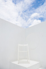 single outdoor white chair with cloud sky and sunlight at rooftop