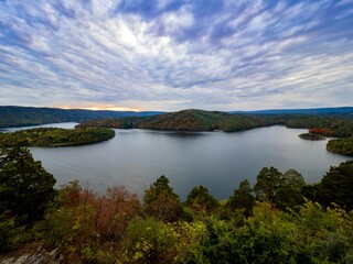 Fototapeta na wymiar Beautiful Hawn’s Overlook of Raystown Lake in the mountains of Pennsylvania, right before sunset with the sky swirled with blue, pink, purple and orange and the water smooth as glass.