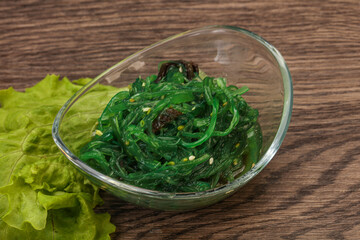 Green Chuka Seaweed Salad Isolated on White Background Top View. Wakame Sea Kelp Salat