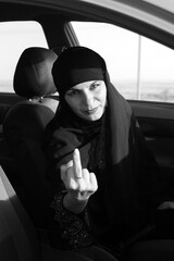 The woman driver shows an indecent gesture Raised middle finger.