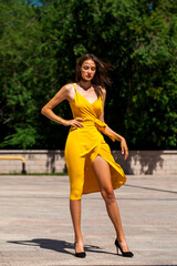 Young brunette woman in yellow dress