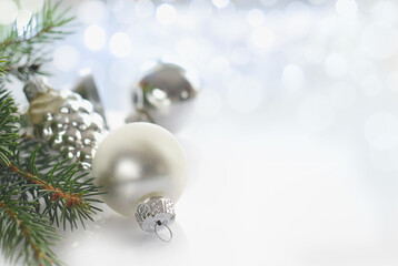 Beautiful christmas card with silver colored balls and light effects defocused garland