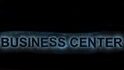 Close-up view of the text Business center on the dark background. Sign Business center on the marble wall. Space for text.