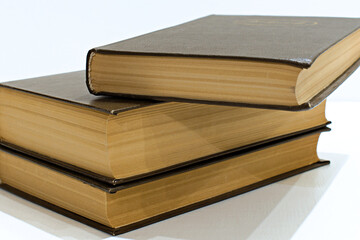 old yellowed hardback books on table background