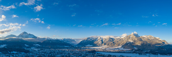 Panorama at sunrise in reutte on a winter's day with mountains thaneller and hahnenkamm