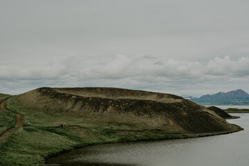 The coastline around the pond Stakholstjorn with pseudo craters - natural monument near Lake Myvatn in Northern Iceland in summer- vintage with grain