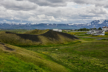 The coastline around the pond Stakholstjorn with pseudo craters - natural monument near Lake Myvatn in Northern Iceland in summer