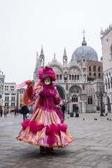 Fototapeta na wymiar Venice, Italy - February 17, 2020: An unidentified woman in a carnival costume in Piazza San Marco attends at the Carnival of Venice.