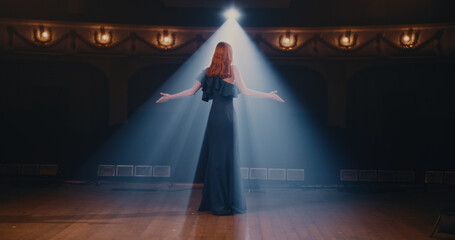Young actress speaking passionately on stage