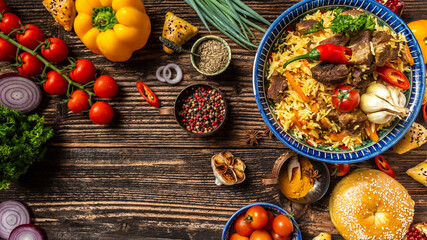 Traditional uzbek meal called pilaf. Rice with meat, carrot and onion in plate with oriental ornament, Uzbek oriental cuisine. Long banner format. space for text