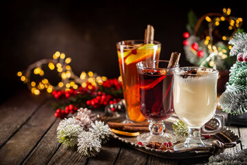 fresh yellow eggnog, grog and fruity red mulled wine with Christmas decoration. Selection of autumn...