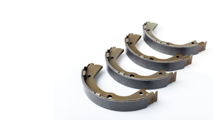 four brake shoes for drum brakes, spare parts for car consumables for service and maintenance of vehicle isolated objects on a white background with copy space horizontal banner, nobody.