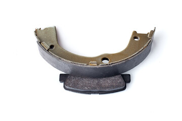 two kinds asbestos brake pads for disc and brake shoe for drum brakes, replacement spare parts of the car brake system isolated on white background, nobody.