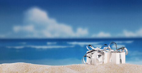 Gifts with silver ribbon in the sand on beach on a sunny day