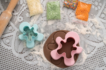 Boy teenager prepares for Christmas and bakes gingerbread men. Good New Year spirit. Delicious cookies.