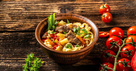 Lagman on wooden background Uzbek restaurant concept Uzbek food. Food recipe background
