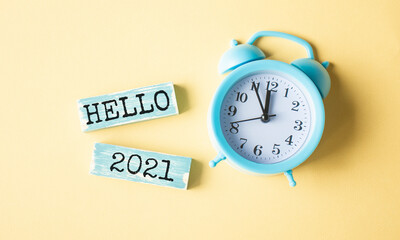 Hello 2021 - word from wooden blocks with letters, happy new year hello 2021 concept.