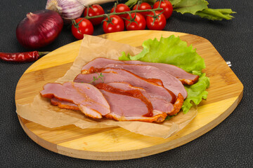 Sliced smoked duck breast served salad