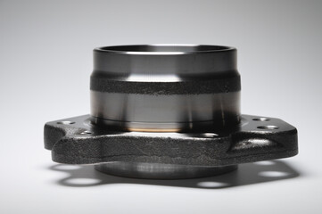 New wheel bearing in a metal housing on a black-white gradient background. New car suspension parts