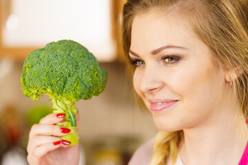 woman holding broccoli vegetable