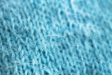Knitted wool fabric texture background. Soft focus. Macro blur background. Blue woolen hand-knitted