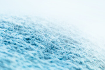 Knitted wool fabric texture background. Soft focus. Macro blur background. Blue woolen hand-knitted