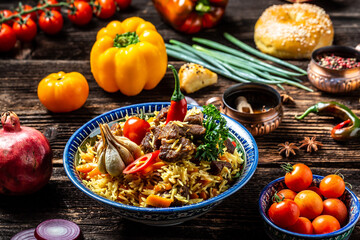 Fototapeta na wymiar Traditional uzbek meal called pilaf. Rice with meat, carrot and onion in plate with oriental ornament, Uzbek oriental cuisine. Long banner format. space for text