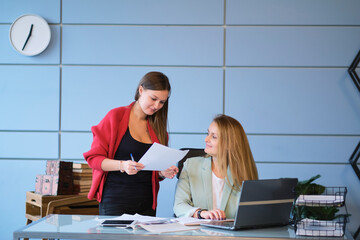 senior mentor a colleague teaches a junior employee. Office. Concept of work.