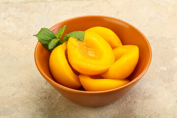 Sweet ripe canned peaches with mint