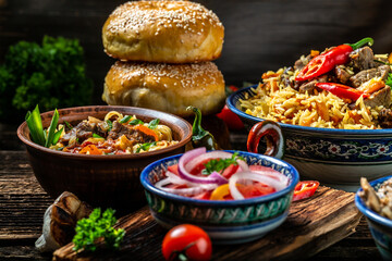 Uzbek and Central Asia cuisine concept. Assorted Uzbek food pilaf samsa lagman manti shurpa Uzbek restaurant concept Uzbek food. Food recipe background. space for text