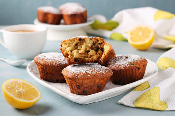 Homemade lemon muffins with chocolate on a white plate on a light blue background, Closeup