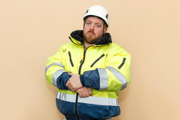 Male industrial worker in winter clothes. Bearded engineer with white hard hat helmet. Climber