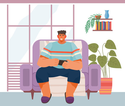 Man uses the phone for entertainment. Male character relaxing on the couch on the weekend and using a modern electronic device. Person has fun in his free time with the help of modern technologies