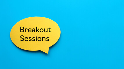 Top view of yellow speech bubble written with Breakout Sessions on blue background with copy space.