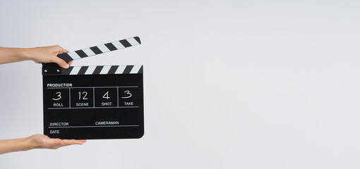 Hands is hold black Clapper board or Clapperboard or movie slate write in number. it use in video production ,film, cinema ,movie industry on white background.