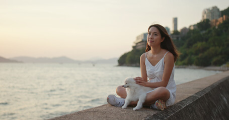 Woman enjoy sunset view with her dog