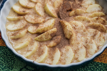 Homemade apple pie on a white wooden background near the window close-up and copy space. Charlotte in the morning on the table.