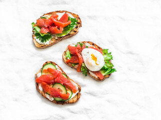 Sandwiches with smoked salmon, green salad and egg. Delicious breakfast, snack