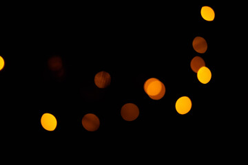 Texture of blurred bokeh colorful lights on black background