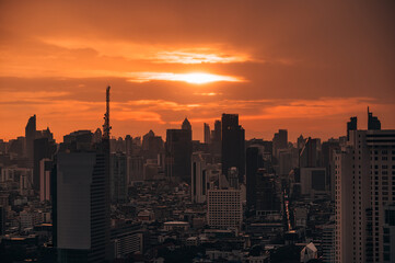 Sunrise over high-rise office building in business district at Bangkok