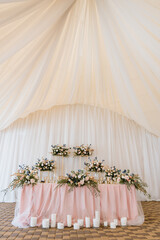 Indoors wedding reception venue with d cor, selective focus on flowers