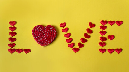 The word Love is made up of red hearts and lollipop heart-shaped. The font of hearts