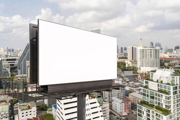Blank white road billboard with Bangkok cityscape background at day time. Street advertising poster, mock up, 3D rendering. Side view. The concept of marketing communication to promote or sell idea.
