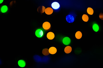 Texture of blurred bokeh colorful lights on black background