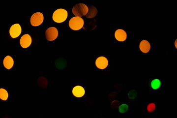 Texture of blurred bokeh colorful lights on black background